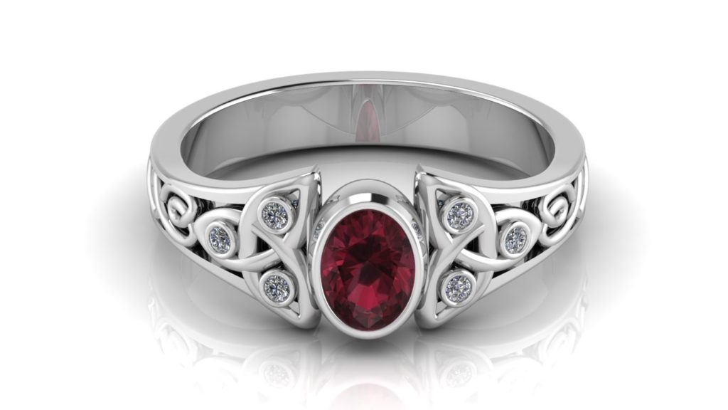 White gold celtic knot ring featuring a bezel set garnet and diamond accents