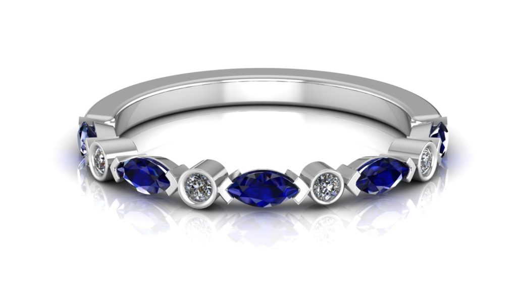 White gold ring featuring alternating round diamonds and marquise cut ceylon sapphires