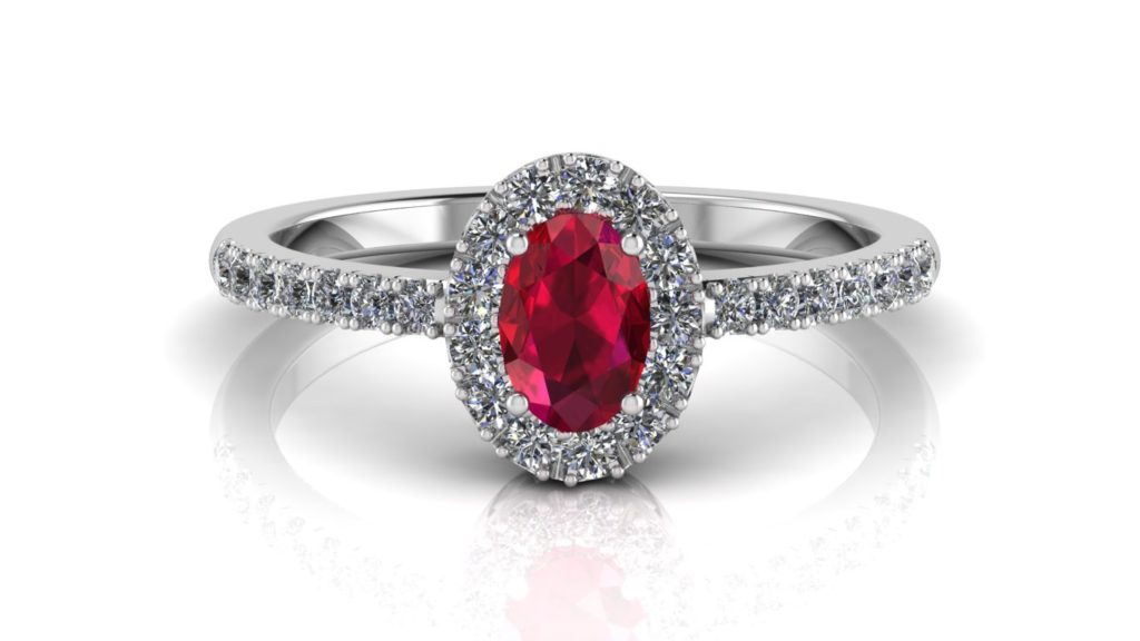 White gold halo ring featuring an oval cut ruby with diamonds
