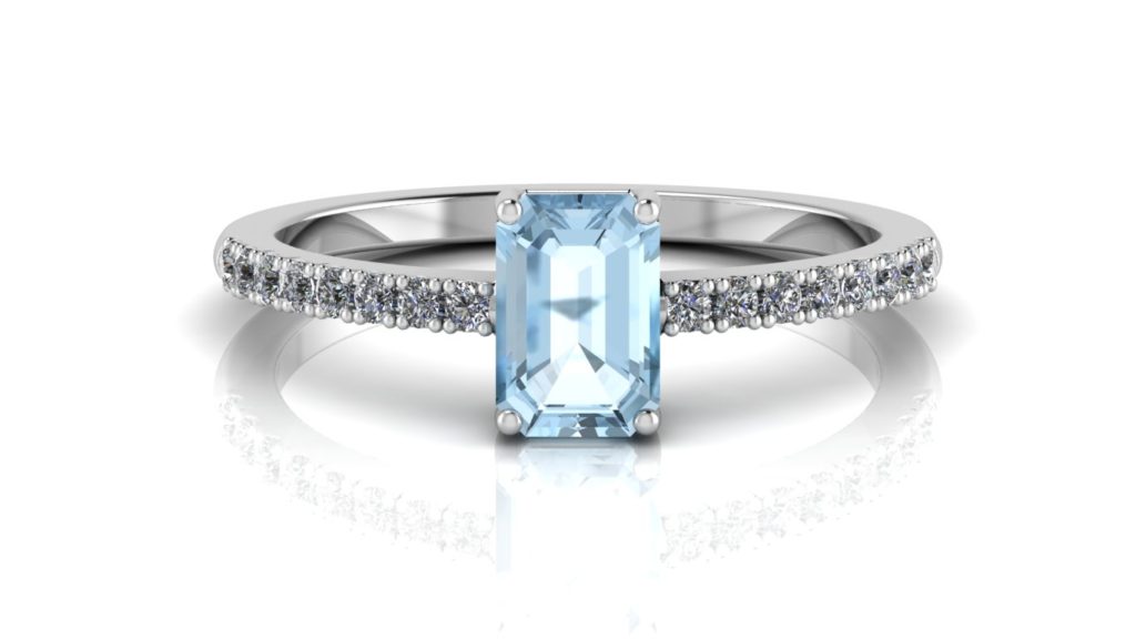 White gold ring featuring an emerald cut aquamarine with diamonds