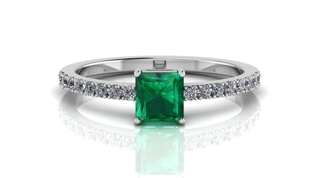 White gold ring featuring a square shaped emerald with diamonds