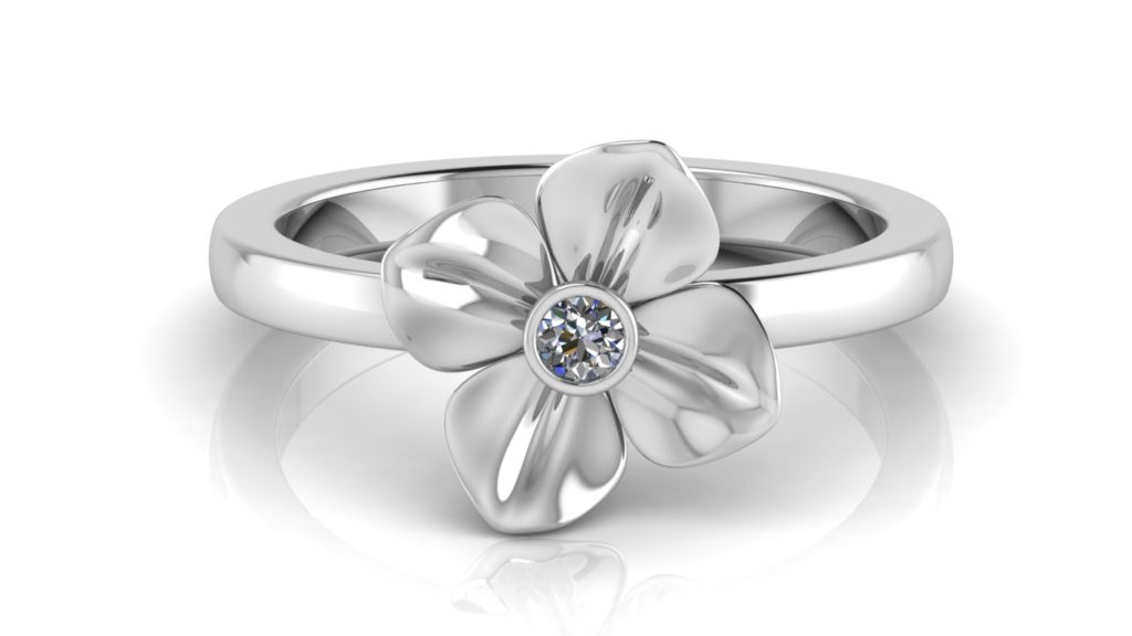 White gold flower ring featuring a bezel set diamond