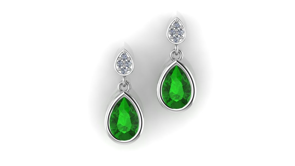 White gold studs featuring a bezel set tsavorite and accent diamonds