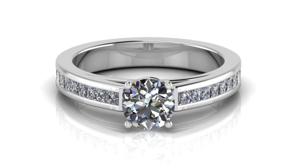 White gold engagement ring featuring a claw set round diamond and smaller channel set princess cuts down the band