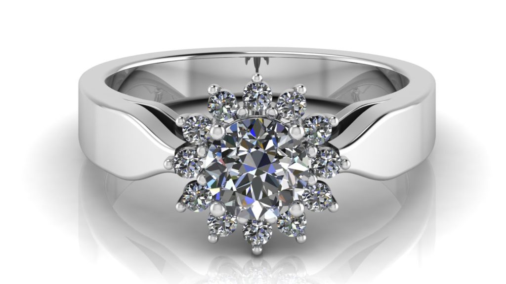 White gold cluster style engagement ring featuring a claw set round diamond and smaller surrounding diamonds