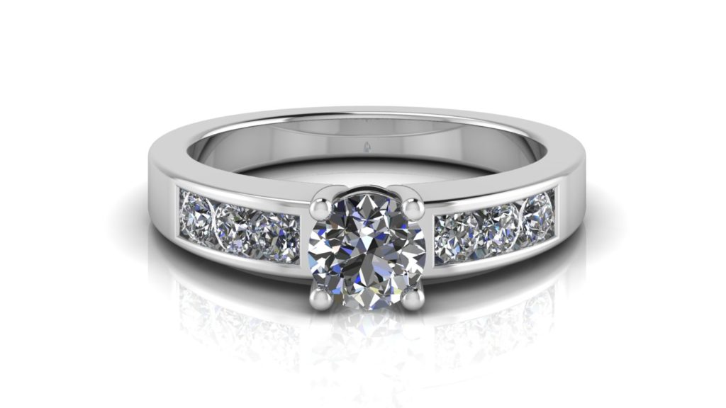 White gold engagement ring featuring a claw set round diamond with channel set diamonds down the band