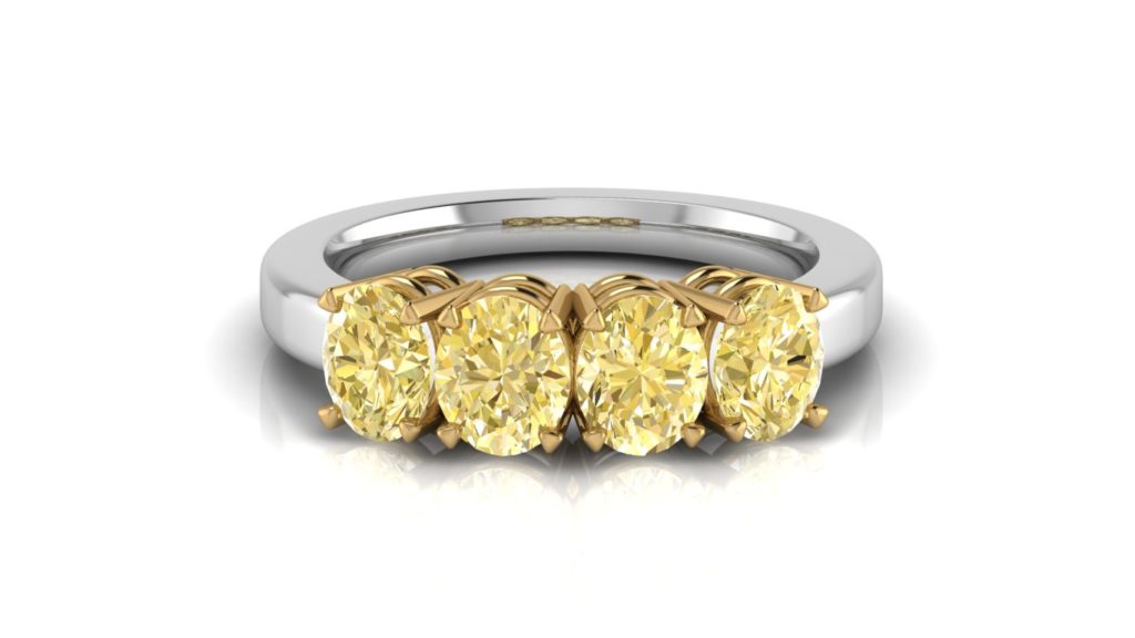 Yellow & white gold ladies ring featuring four natural oval cut yellow diamonds