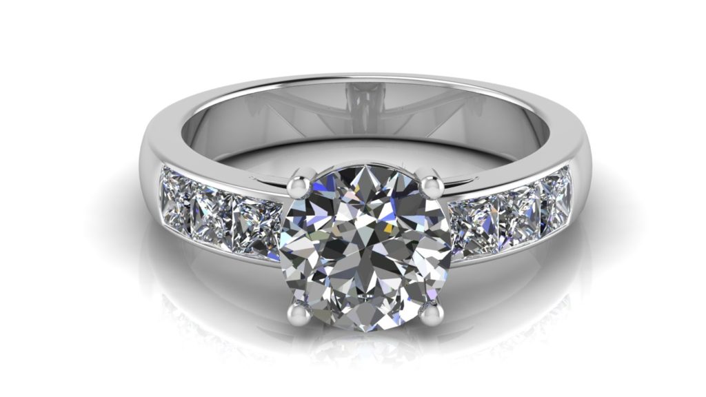 White gold engagement ring featuring a claw set round diamond with channel set princess cut diamonds down the band