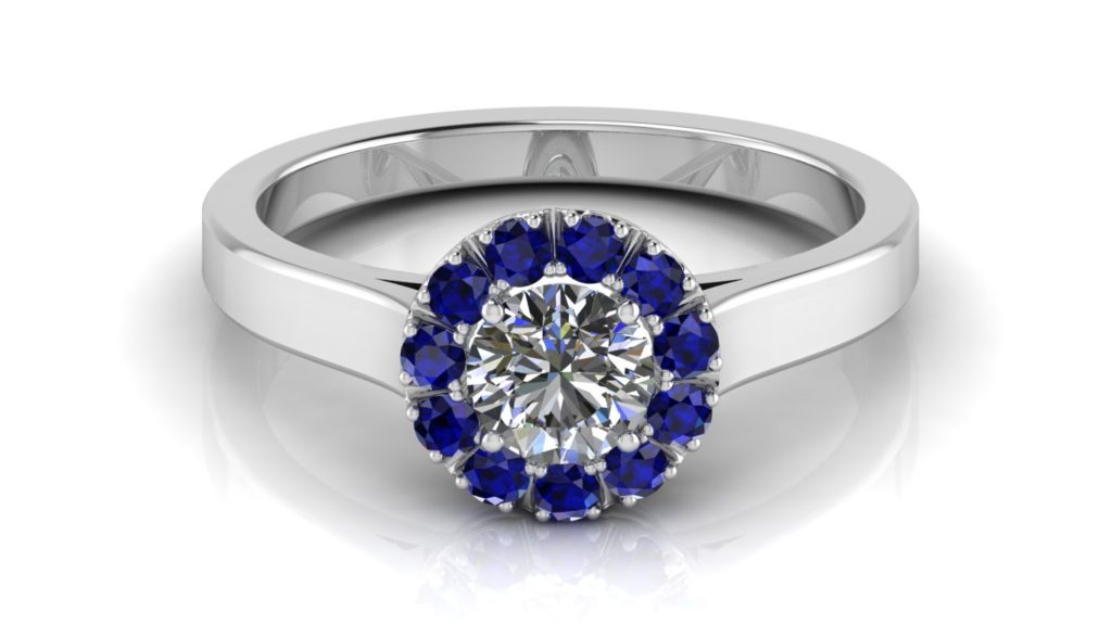 White gold halo engagement ring featuring a round diamond and smaller ceylon sapphires