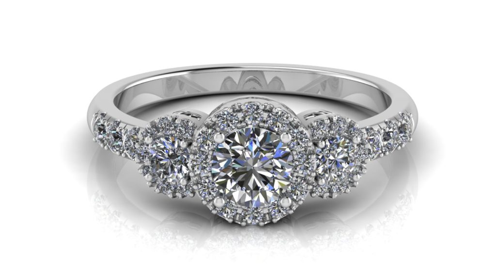 White gold halo engagement ring featuring three round diamonds and smaller diamonds down the band