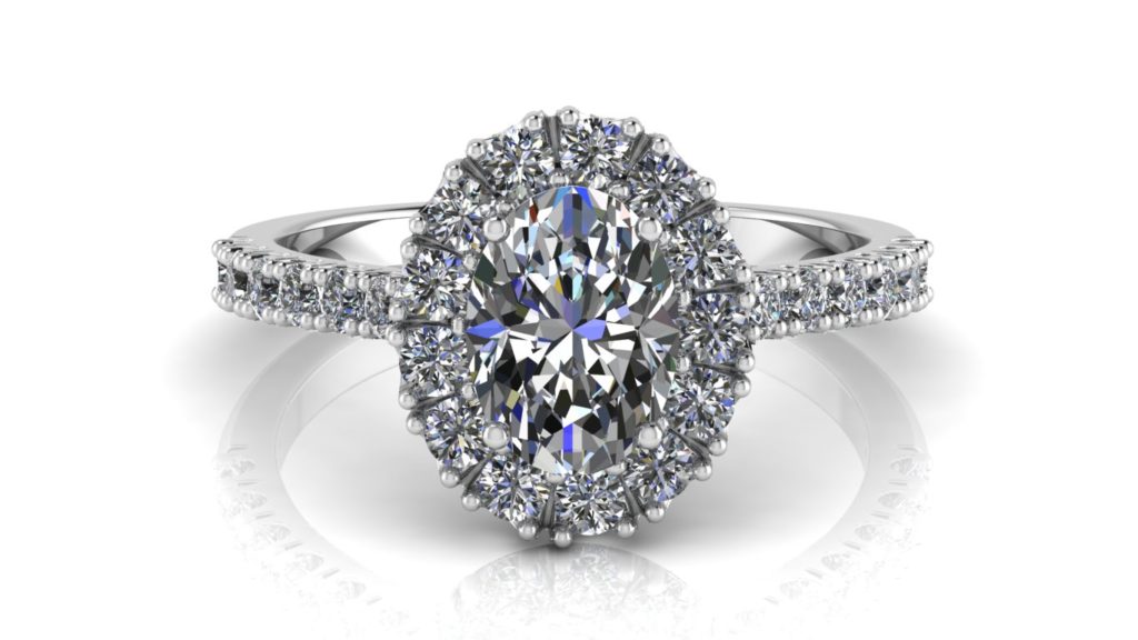 White gold halo engagement ring featuring an oval cut diamond with smaller diamonds down the band