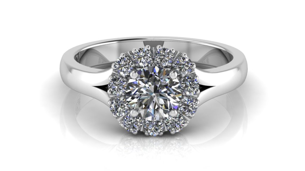 White gold engagement ring featuring a claw set round diamond and cushion shaped diamond halo