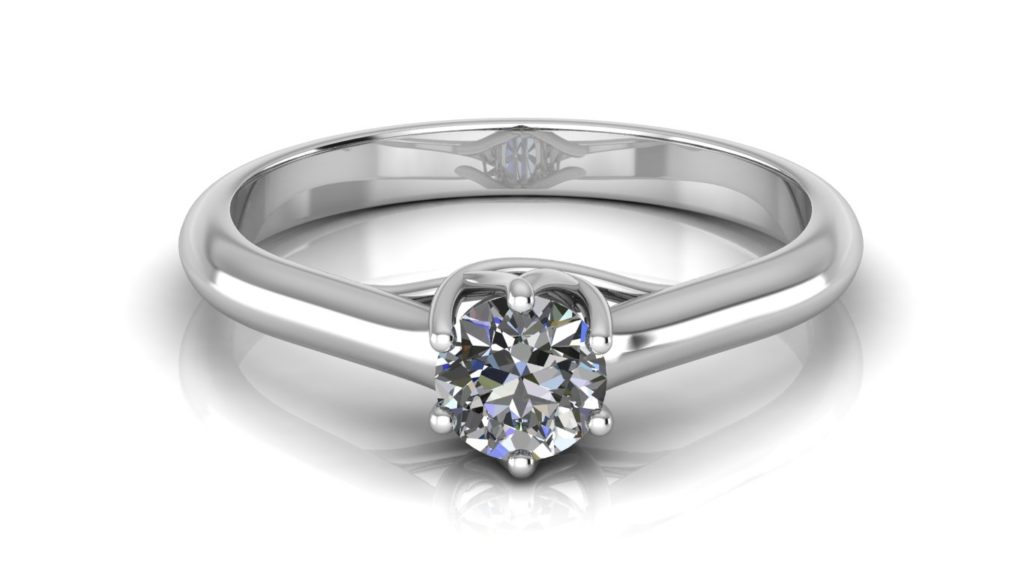 White gold solitaire engagement ring featuring a claw set round diamond