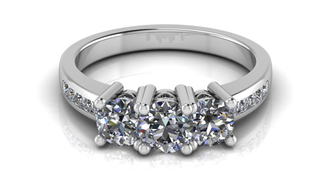 White gold three stone engagement ring with channel set diamonds down the band and side heart motifs