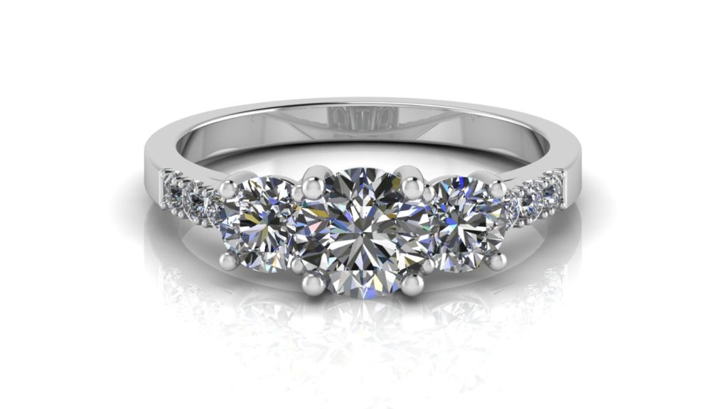 White gold three stone engagement ring with smalle diamonds down the band