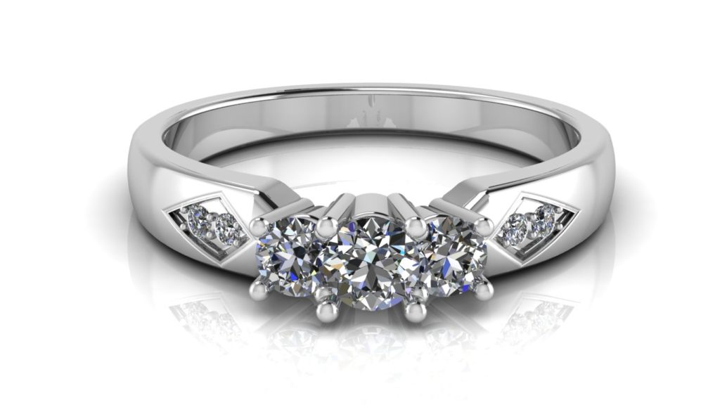 White gold three stone engagement ring with smaller accent diamonds set in a diamond shape motif