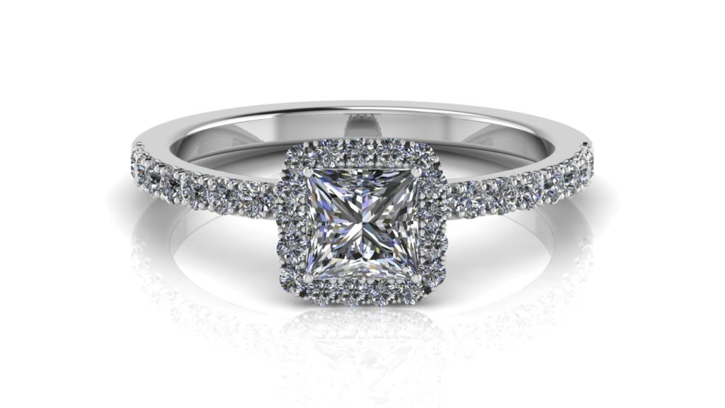 White gold halo engagement ring featuring a princess cut diamond with smaller diamonds down the band