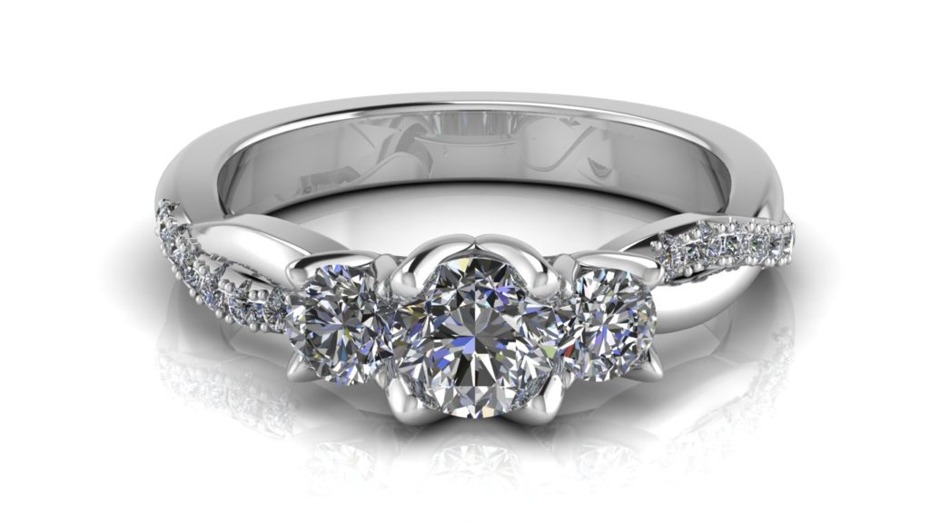 White gold three stone engagement ring with smaller diamonds down a twisted band
