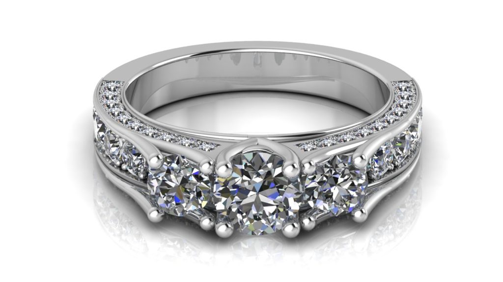 White gold three stone engagement ring with pave set diamonds down the band and sides