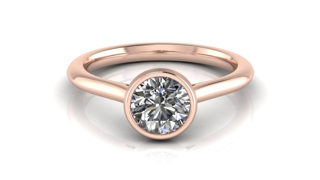 Rose gold engagement ring featuring a bezel set round diamond