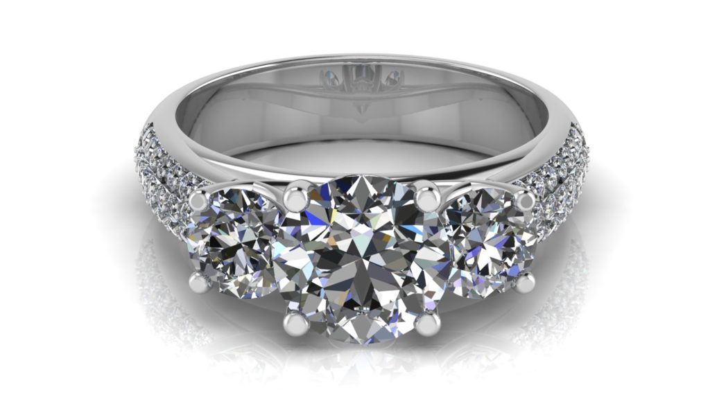 White gold three stone diamond engagement ring with micro pave set diamonds down the band
