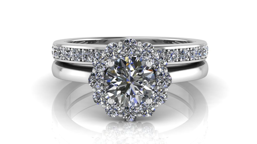 White gold flower halo engagement ring featuring a round diamond and pave set diamond wedding band