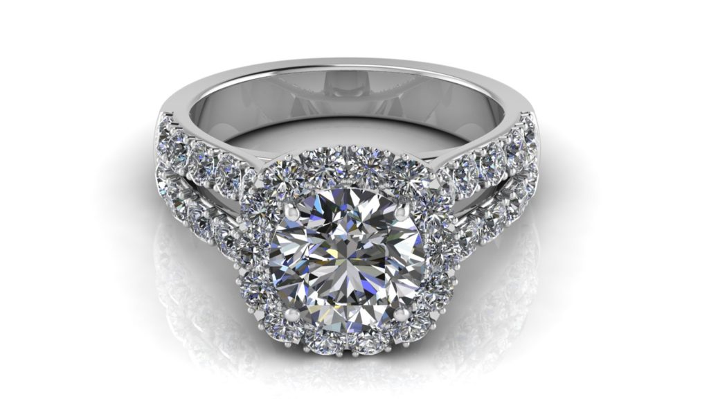 White gold split shank cushion halo engagement ring featuring a round diamond and smaller diamonds down the band