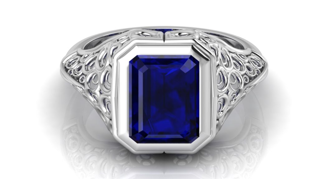 White gold filigree signet style ring featuring an emerald cut ceylon sapphire