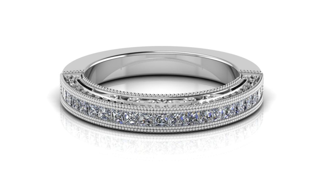 White gold ladies ring featuring channel set princess cut diamonds with milgrain accents and side scrolll work