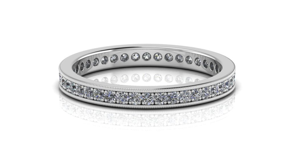 White gold ladies eternity ring featuring pave set round diamonds with milgrain edges