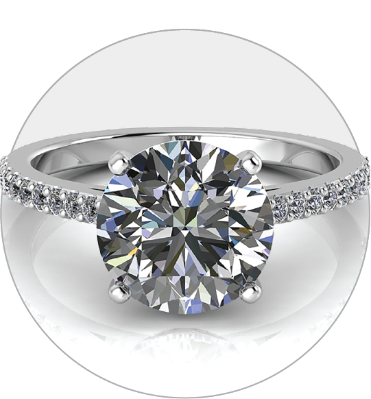 White gold split shank cushion halo engagement ring featuring a round diamond and smaller diamonds down the band